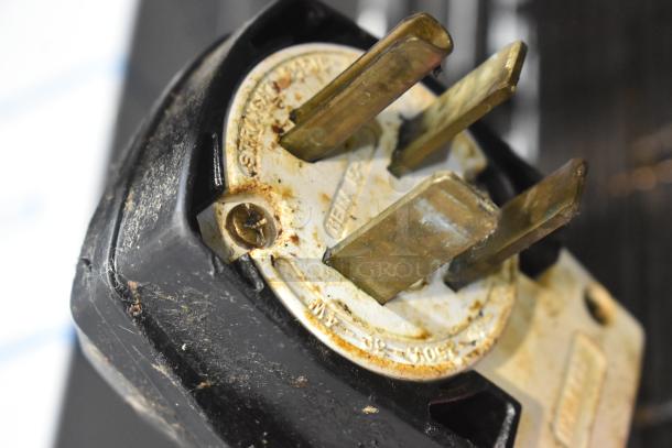 Close-up of a power plug for a Turbochef HhC2020 commercial conveyor oven, showing wear and voltage markings.