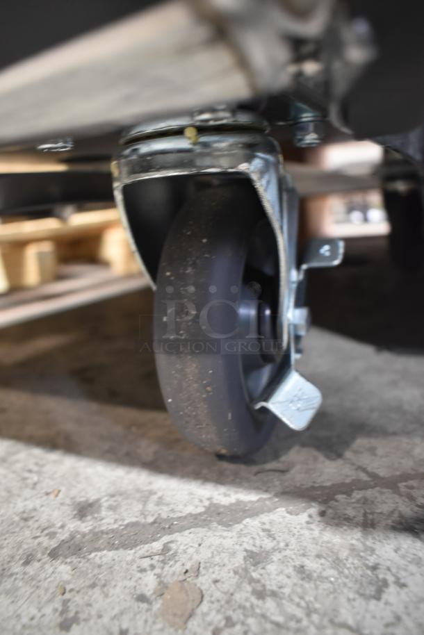 Commercial caster wheel on Avantco 177HPI1836 heated cabinet, showcasing mobility feature.