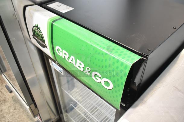 Brand new 2025 Avantco 360SC80 countertop merchandiser fridge, customizable, 115V, some scratches. "Grab & Go" sign.