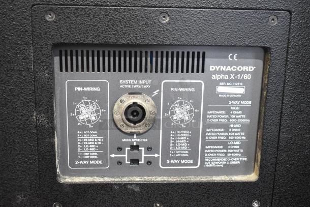 Close-up image of Dynacord Alpha X-1/60 loudspeaker panel with pin-wiring details and mode switches. Serial No. 112616. Made in Germany.