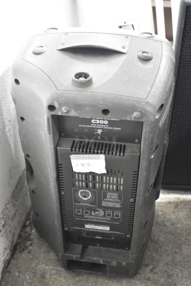 Three speakers including Eurolive B212A, Mackie C300, and Yorkville TX4 in used condition with visible wear. Note the Mackie C300's label detailing "wide dispersion" attributes and a handwritten note with "#253."