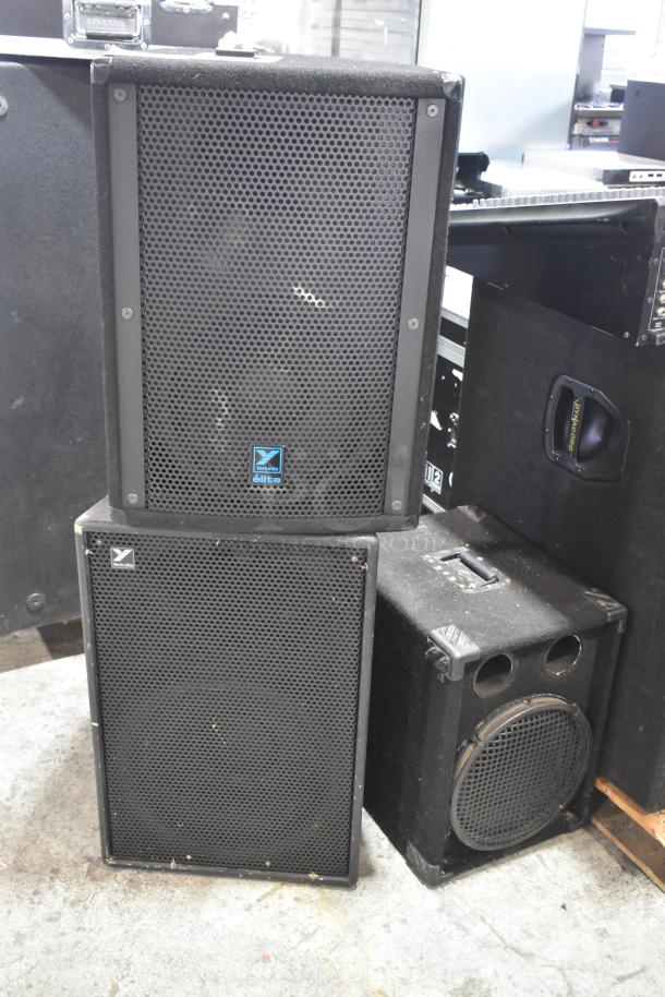 Three speakers including Yorkville Elite E12 passive and Yorkville TX4, showing wear. Ideal for audio setups.
