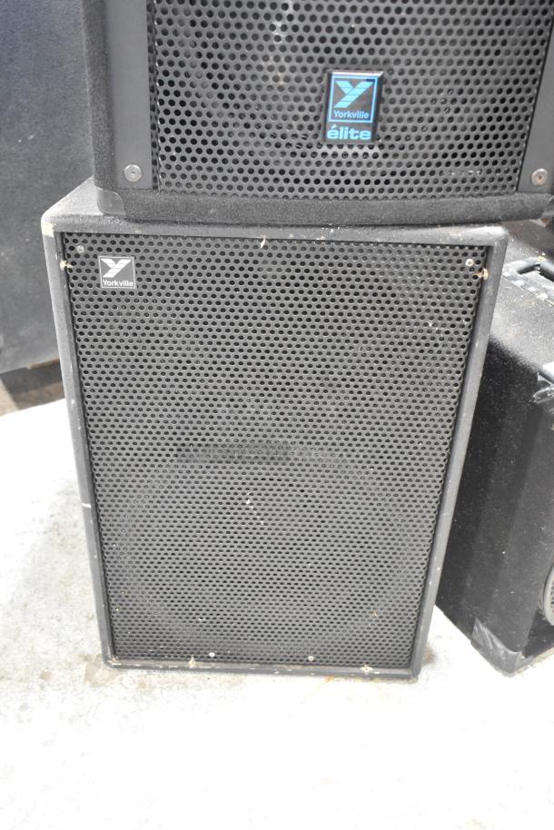 Yorkville Elite E12 speaker and TX4, showing black grille, Yorkville branding, visible wear, ideal for sound systems.