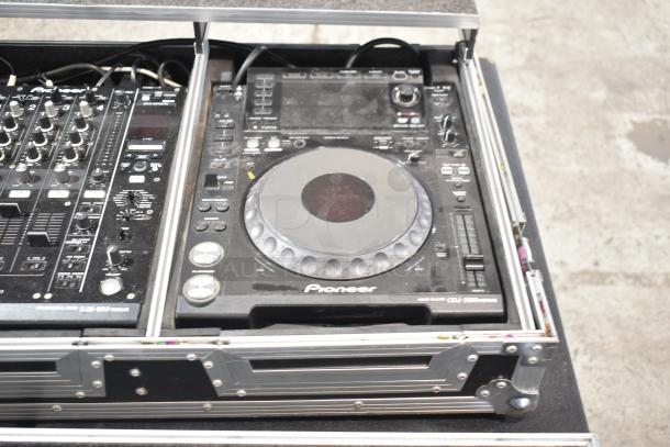 Pioneer CDJ-2000 and DJM-900 Nexus DJ station in a protective case, showing controls and knobs; lightly used condition.