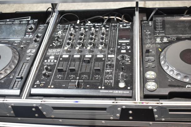 Pioneer CDJ-2000/DJM-900 Nexus DJ station in protective case, featuring multi-player controls and mixing functions.