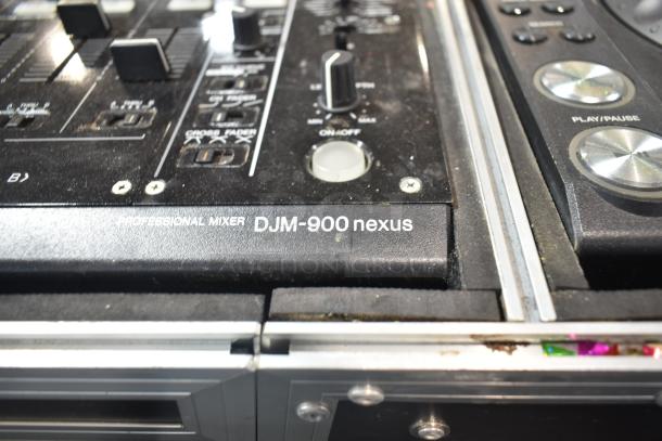 Close-up of Pioneer DJM-900 Nexus Professional Mixer with visible controls and buttons. Dust present on surface.