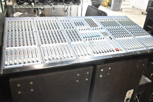 Yamaha IM8-32 sound console with multiple faders, dials, and controls, paired with a Dynacord FX20 cabinet speaker in auction.