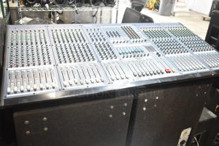 Yamaha IM8-32 sound console with multiple faders, dials, and controls, paired with a Dynacord FX20 cabinet speaker in auction.