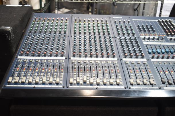 Yamaha IM8-32 sound reinforcement console with multiple input channels and faders, in good condition; ideal for professional audio setups.