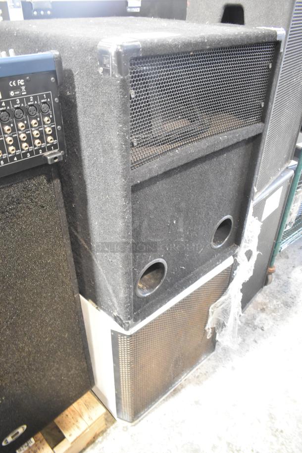 Two speakers, including JBL MRX500 loudspeaker and Electro-Voice S-181 subwoofer. Visible ports and connection panel. Signs of use.
