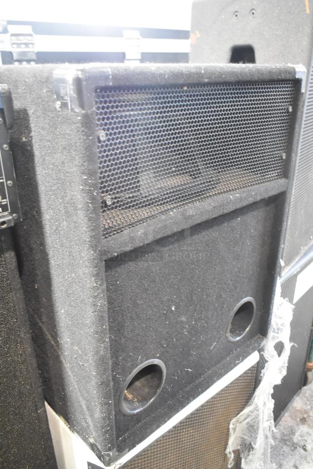 JBL MRX500 passive loudspeaker, rugged mesh grille, visible edge wear, stacked with Electro-voice S-181 subwoofer.