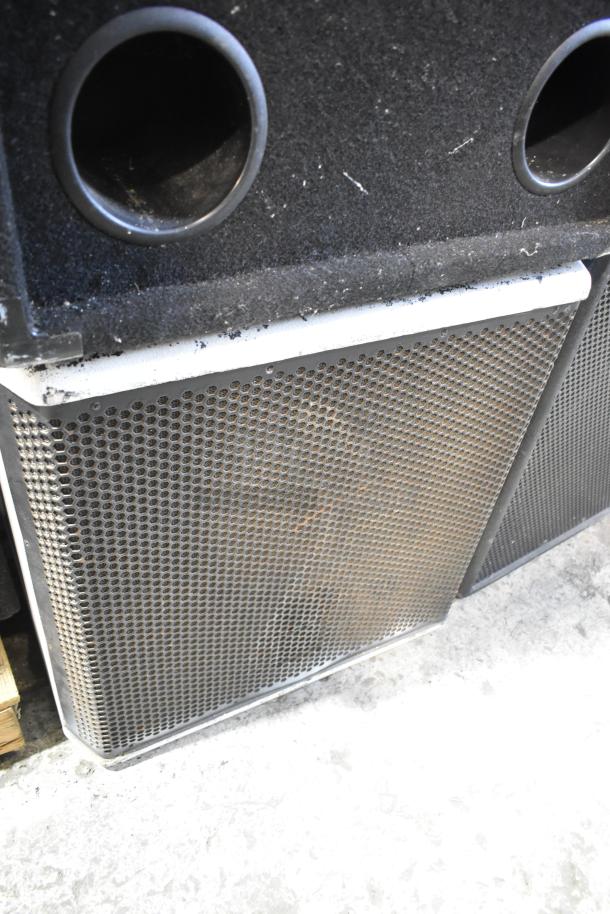Pair of speakers, including JBL MRX500 loudspeaker and Electro-voice S-181 subwoofer, visible grills and ports, used condition.