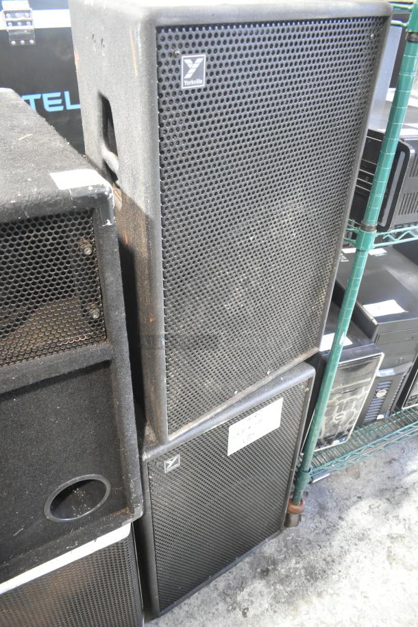 Three speakers including Yorkville TX4 models, stacked in used condition, with visible grill and logos.