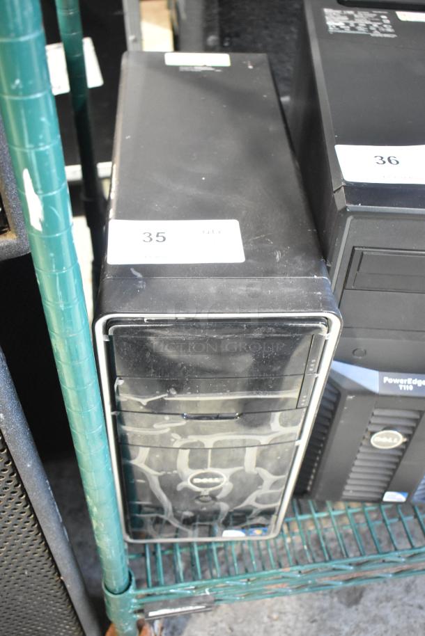 Dell DCMF computer tower, 115/230 volts, 1 phase. Black casing with surface wear, includes original Dell logo.