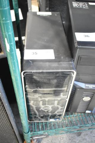 Dell DCMF computer tower, 115/230 volts, 1 phase. Black casing with surface wear, includes original Dell logo.
