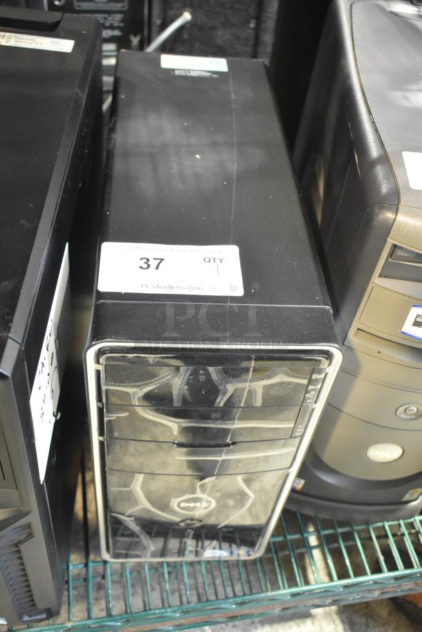 Dell DCMF computer tower, 115/230 volts, 1 phase. Black casing, visible scuffs, auction tag with number 37.
