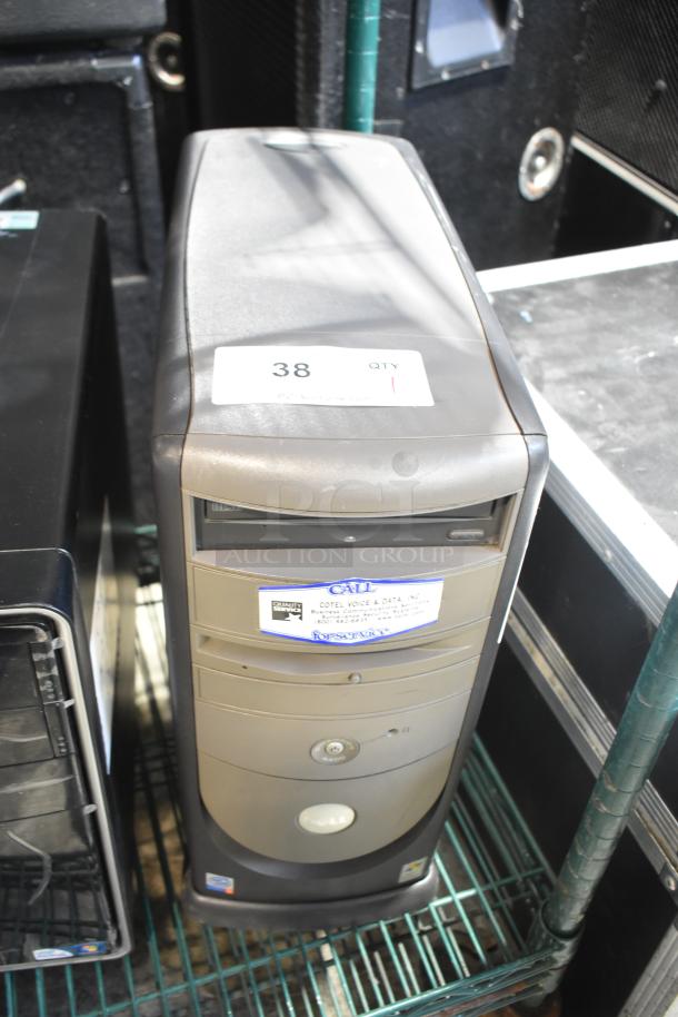 Dell computer tower, beige casing, labeled "38" with service tag, in used condition.