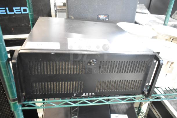 LG rack unit, black, with vented front panel, minor surface wear, mounted on a metal shelf. No visible labels or tags.