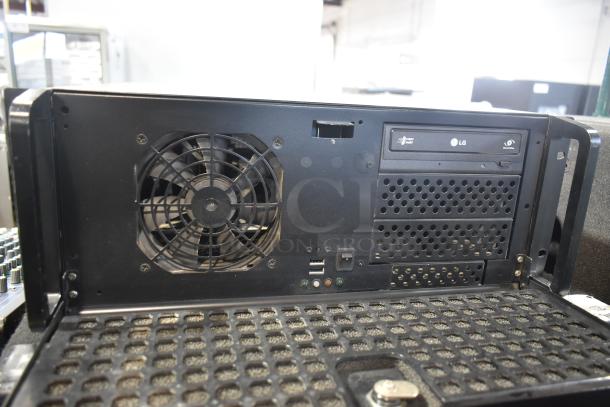 LG rack unit with cooling fan, USB ports, and optical drive. Black casing, minor wear. Ideal for server setup.