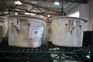 4 Bose FreeSpace DS 16F Loudspeakers on display rack, beige, label with auction details.