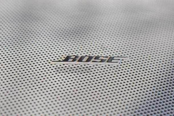 Bose FreeSpace DS 16F loudspeaker with perforated grille and Bose logo, highlighting brand and sleek design.