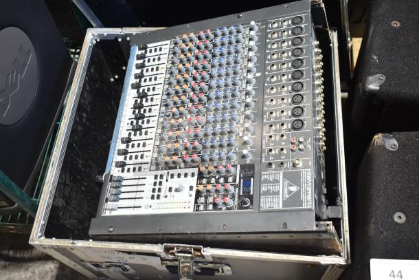 Behringer Xenyx 2442FX 24-Input Mixer in hard case, featuring XENYX mic preamps, British EQ, and multi-FX processor.