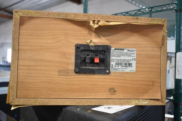 Rear view of a Bose 201 V speaker showing connection ports and label details. Visible damage on corner, moderate condition.