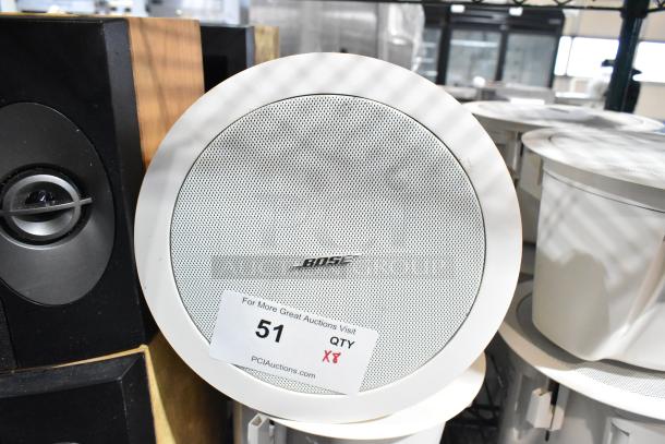 4 Bose FreeSpace DS 16F Loudspeakers, white finish, new condition. Includes auction tag with lot number 51.