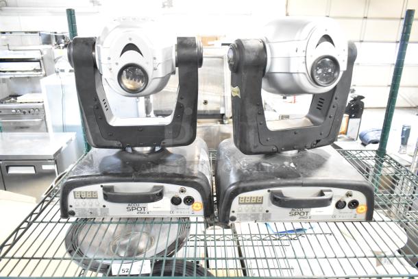 2 American DJ Accu Spot 250 II moving head lights on a shelf. Features DMX control, visible condition marks.