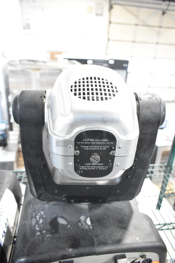 Two American DJ Accu Spot 250 II DMX moving head lights for club stages, featuring adjustable lamp positioning.