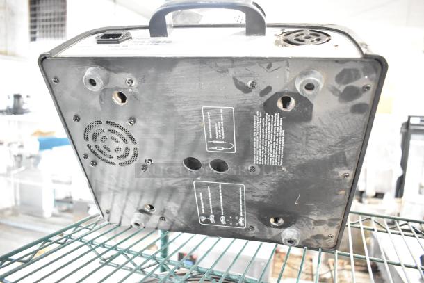 2 American DJ Accu Spot 250 II moving head lights, black, underside view, includes vent and connection labels, used condition.