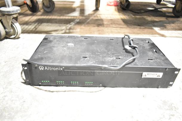 Altronix R2416300ULCB power supply, black, used condition, visible labels and status lights, auction item.