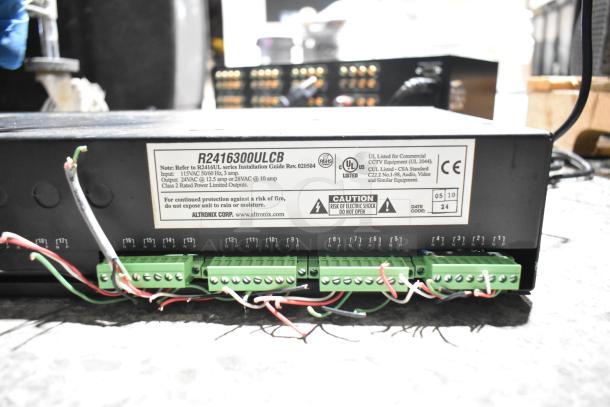 Altronix R2416300ULCB Power Supply with wiring and label showing voltage details; UL and CE listed certification marks.