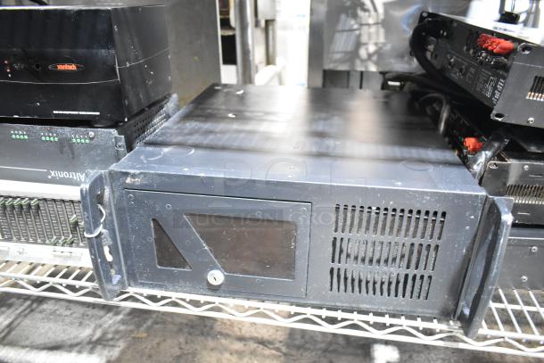 Rack-mounted electronic units including a DVD player and LG rack unit, featuring ventilation grilles, in used condition.