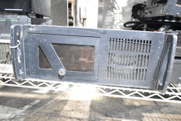 DVD playing unit and LG rack unit, both in metal cases, shown with some surface wear, positioned on a storage rack.