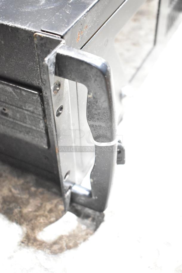 Industrial DVD playing unit with metal casing, visible screws, and handle; paired with LG rack unit. Used condition.