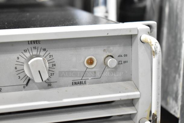 Crown Macro Tech 3600VZ Power Amplifier, showing its control panel with a level knob and enable switch. Visible wear.