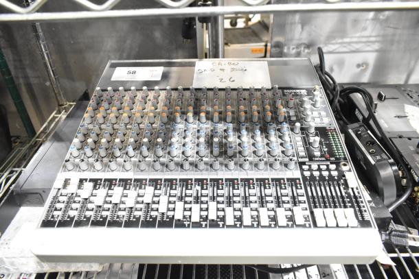 Mackie 1604-VLZ3 Premium Mic/Line Mixer, 16 channels, labeled knobs, faders. Appears in used condition on metal shelf.