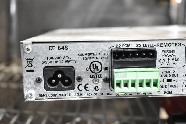 Close-up of a Rane CP 64S Commercial Processor showing power specifications, input/output connectors, and UL certification.
