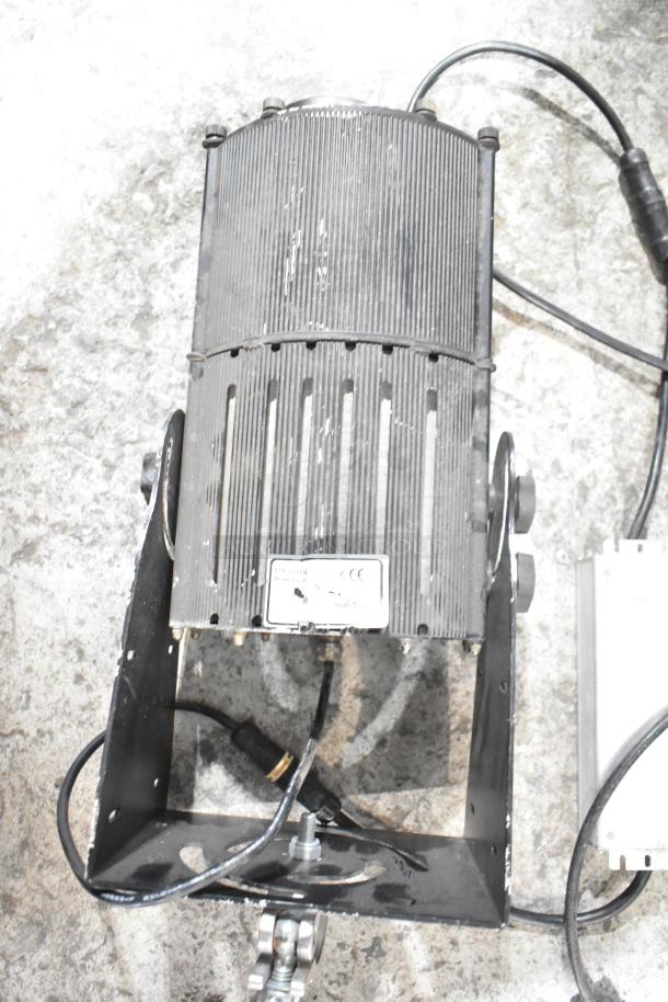 GoboSource ES-B10E stage light; black metal casing, equipped with power cable and mount bracket; wear visible.