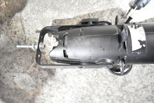 Black GoboSource ES-B10E stage light, showing metal mounting bracket and bolt, in used condition on concrete surface.