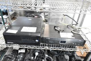 Two items on a shelf, including a Panamax M5100-PM Home Theater Power Conditioner, showing wires and a tag.