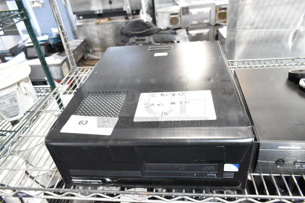 Two electronic items on a metal shelf, including a Panamax M5100-PM power conditioner. Visible labels show lot number and markings.