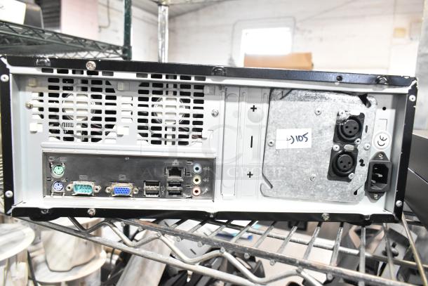 Rear view of electronic equipment, showcasing various ports and connectors. Includes ventilation and metal casing.
