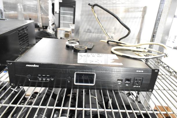 Panamax M5100-PM Home Theater Power Conditioner, black, features multiple outlets, USB ports, and control panel; includes cables and remote; tag marked “23” visible.