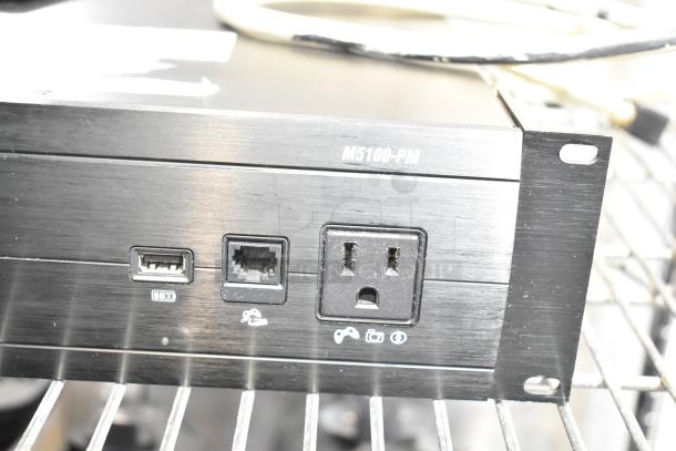 Panamax M5100-PM Home Theater Power Conditioner, features USB and Ethernet ports, visible in rack-mounted condition.