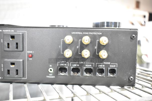 Panamax M5100-PM Home Theater Power Conditioner with multiple outlets, coax protection, and LAN inputs, on metal rack.