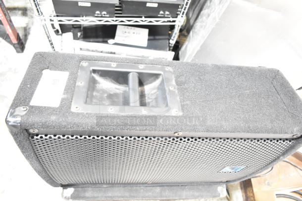 Yorkville Elite E12 speaker with perforated grille, textured exterior, and visible carry handle. Slightly worn condition.