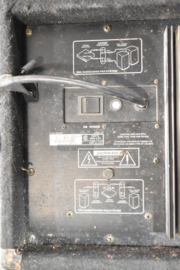 Yorkville LS700P subwoofer rear panel with input/output ports, power switch, and caution labels. Signs of wear.