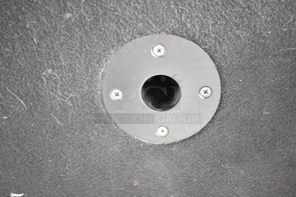 Yorkville speaker cabinet detail with visible mounting port on black surface, part of Elite E12 or LS700P model.